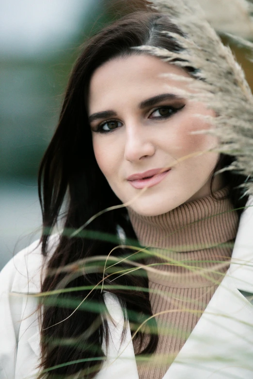 a woman that is standing in the grass, a portrait, trending on pexels, young middle eastern woman, winter season, headshot photograph, fashion shoot 8k