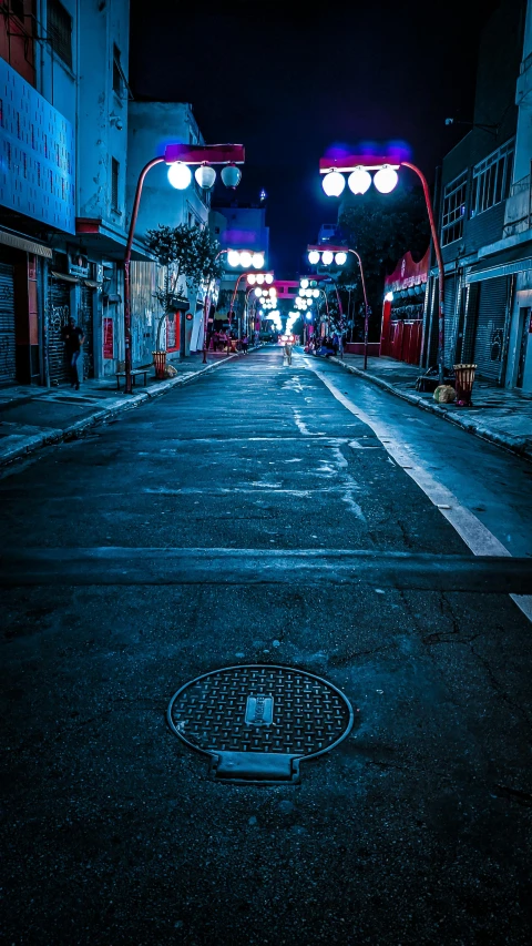 a street filled with lots of lights next to tall buildings, an album cover, unsplash contest winner, mingei, quiet tokyo alley at night, blue and red, filthy streets, taken in the early 2020s