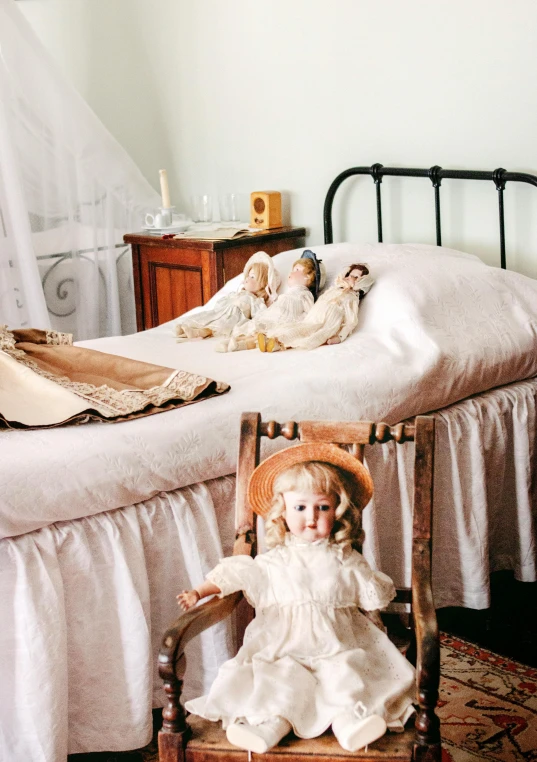 a couple of dolls sitting on top of a bed, old furniture, florence nightingale, 2019 trending photo, small bedroom