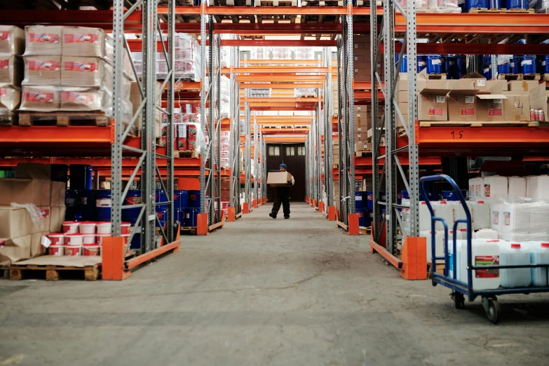 a warehouse filled with lots of boxes and carts, pexels contest winner, renaissance, facing away, avatar image, orange safety labels, portrait photo