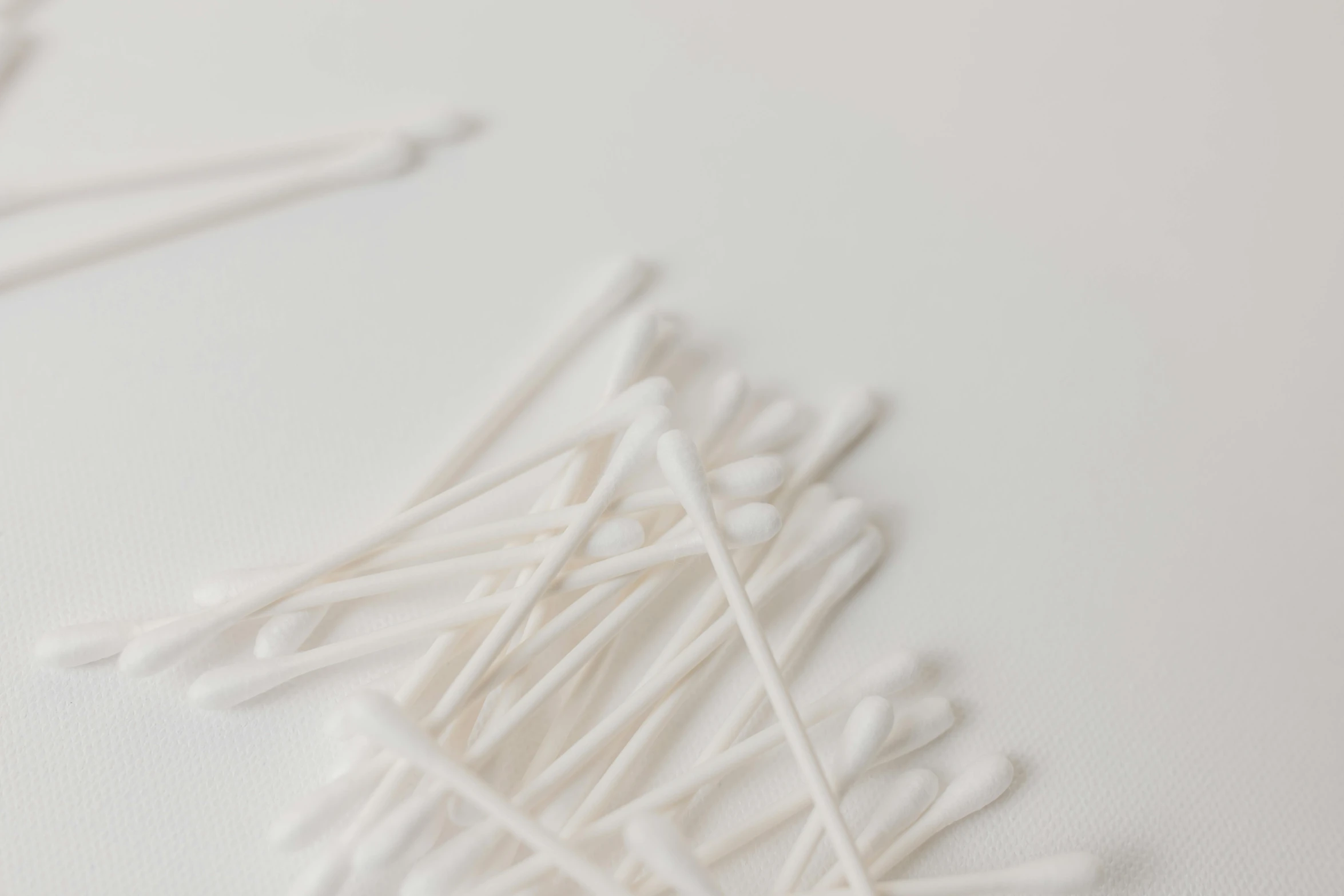 a pile of toothpicks sitting on top of a white table, unsplash, minimalism, silver，ivory, made of lab tissue, earbuds, white lashes