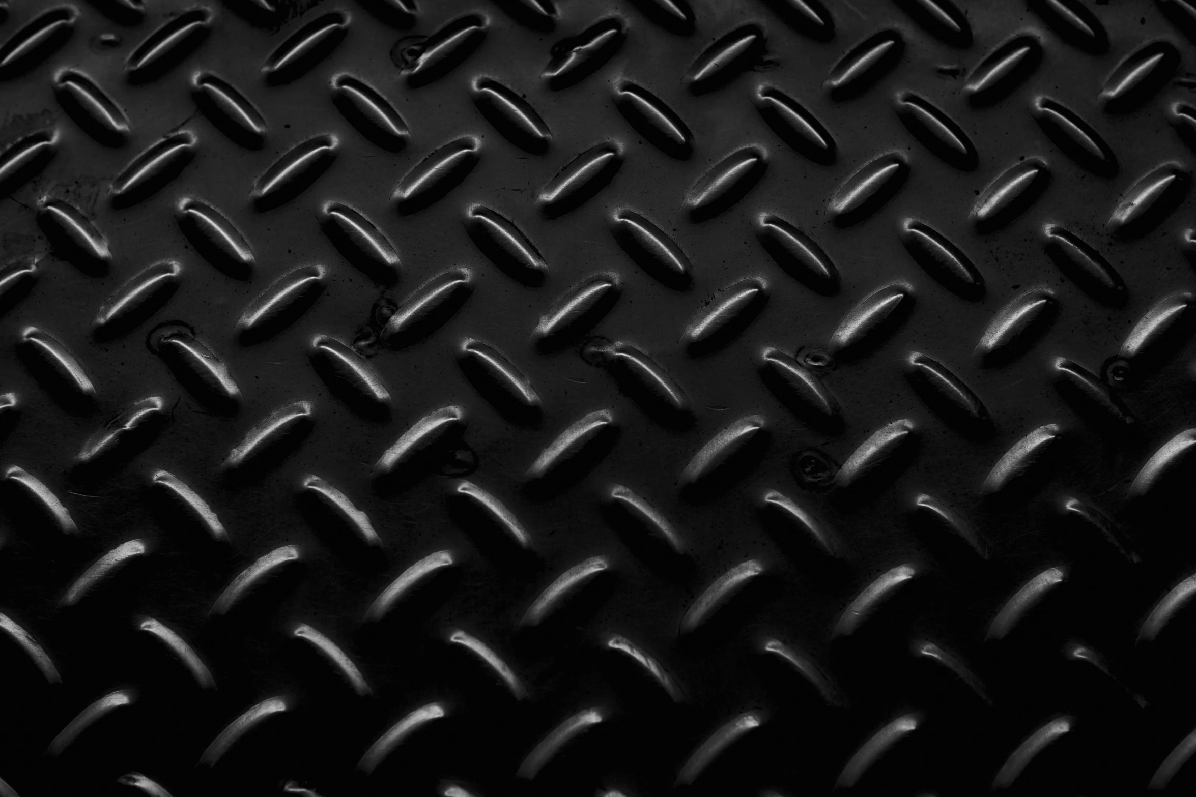 a black and white photo of a metal surface, by Adam Chmielowski, pexels, diamond texture, solid black #000000 background, metal floor, electric