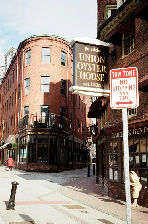 a couple of signs sitting on the side of a road, by Everett Warner, victorian buildings, oysters, boston massachusetts, high res photograph