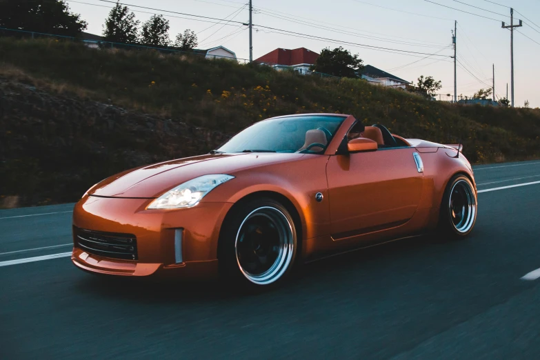 an orange sports car driving down the road, a picture, unsplash, brown body, samurai vinyl wrap, thicc build, nd4