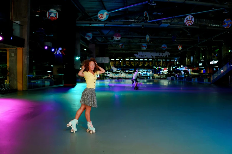 a woman standing on a skateboard inside of a building, bumper cars, in a glowing skirt, with roulettes in the roof,