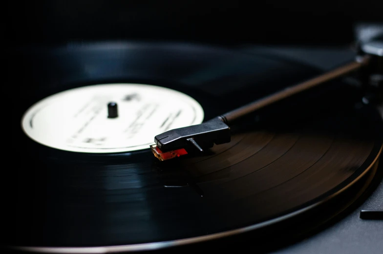 a close up of a record on a turntable, an album cover, trending on pexels, black lacquer, profile image, thumbnail, black