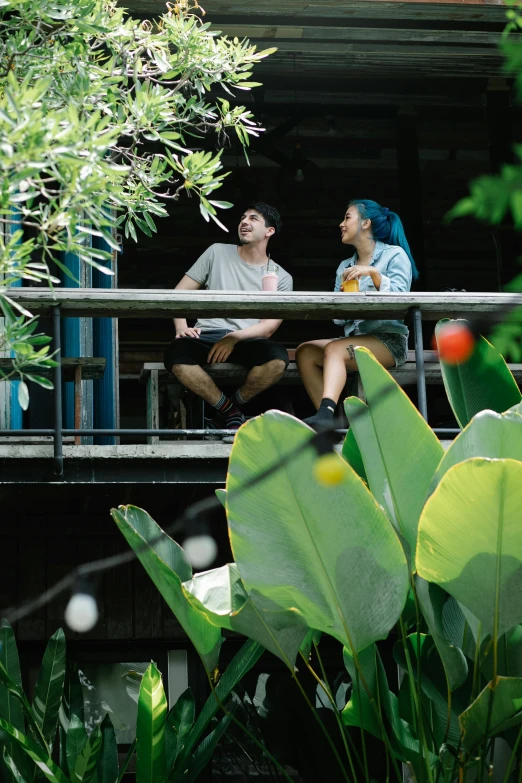 a man and a woman sitting on a balcony, malaysia jungle, teenager hangout spot, vibrant greenery, zac retz