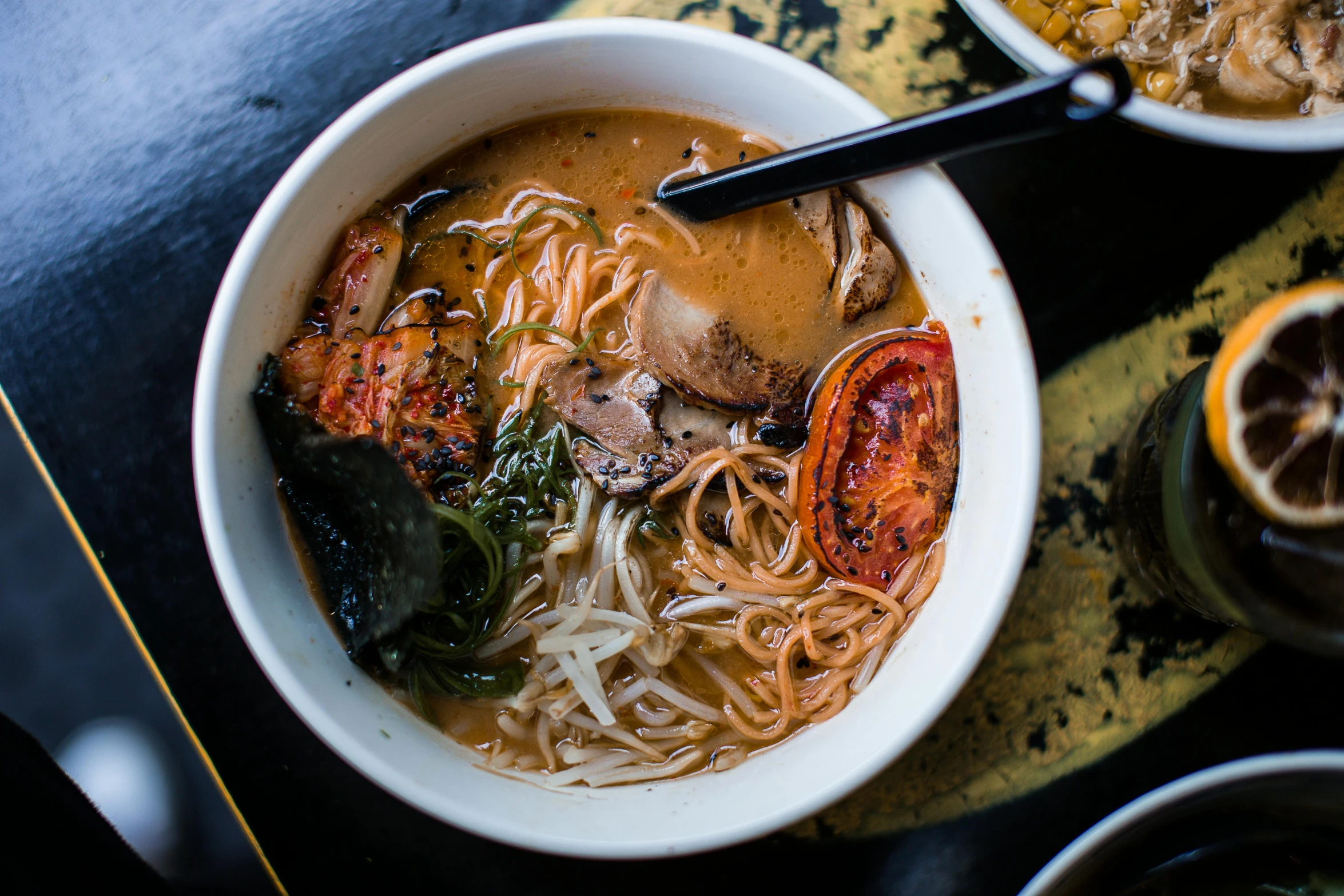 a bowl of soup sitting on top of a table, inspired by Kanō Tan'yū, pexels contest winner, black and gold wires, ramen, 🦩🪐🐞👩🏻🦳, san francisco