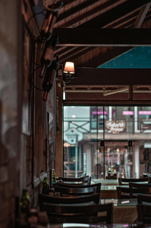 the inside of a restaurant with tables and chairs, a portrait, by Niko Henrichon, trending on unsplash, bars on the windows, outside a saloon, looking through frosted glass, interior of a small