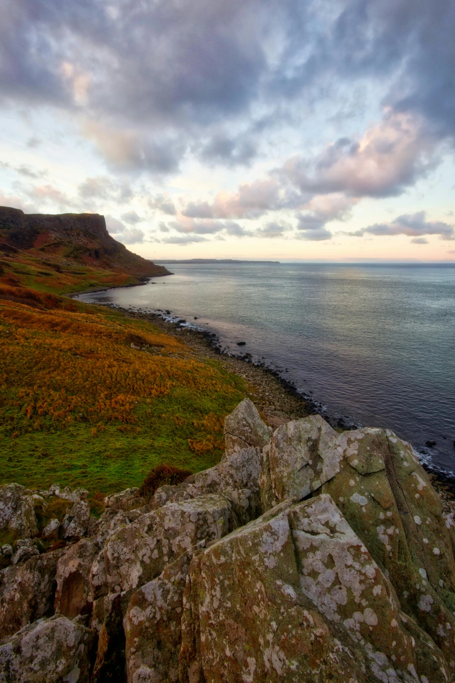 a large body of water sitting on top of a lush green hillside, a picture, by Peter Churcher, romanticism, rocky coast, autum, edinburgh, today\'s featured photograph 4k