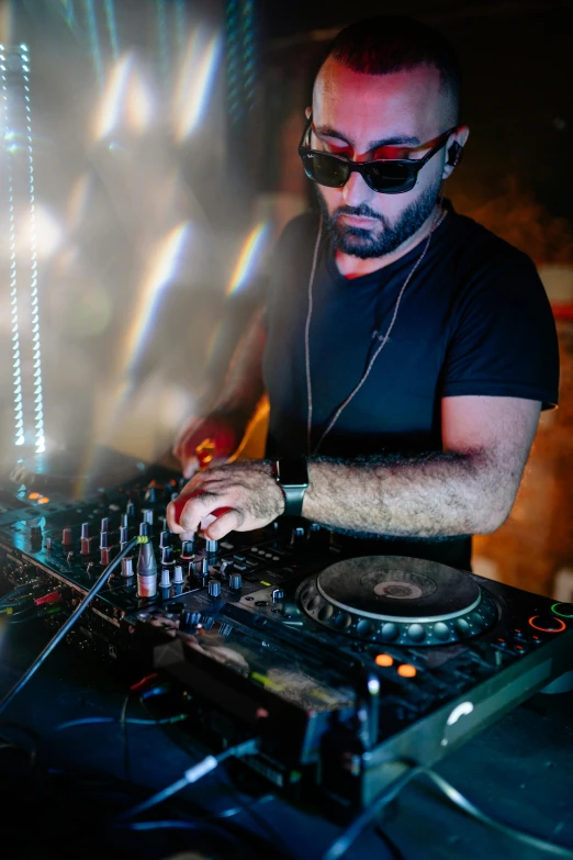 a man that is playing some kind of music, an album cover, pexels, wonderfull techno party, reza afshar, dark shades, mixing drinks