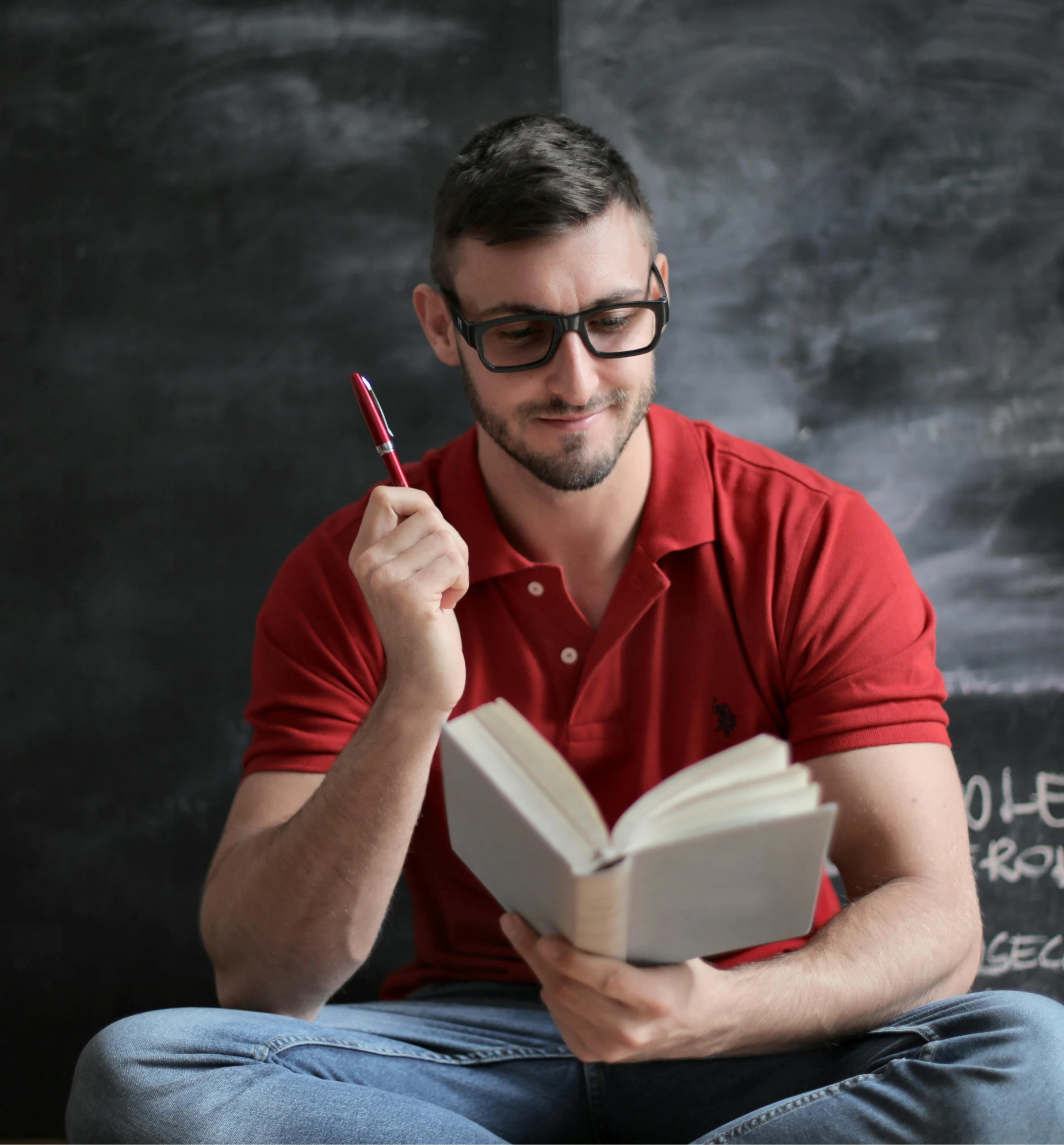 a man in a red shirt is reading a book, a portrait, pexels contest winner, academic art, blackboard in background, nerdy, holding pencil, 15081959 21121991 01012000 4k