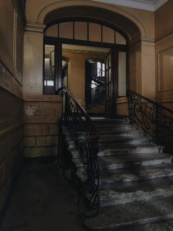 a set of stairs leading up to a building, a colorized photo, inspired by Thomas Struth, pexels contest winner, art nouveau, dark and beige atmosphere, soviet apartment building, entrance, brown