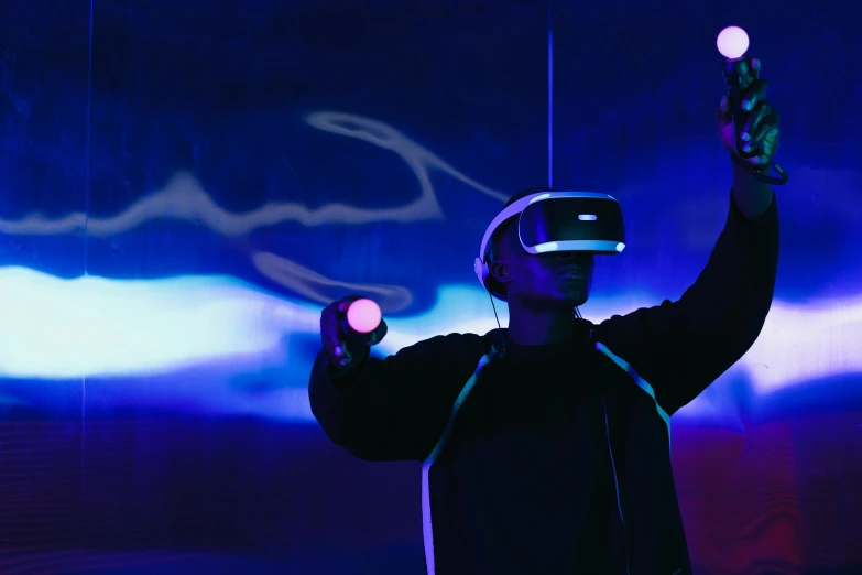 a man standing in front of a blue and purple light, a hologram, unsplash, interactive art, using a vr headset, abzu, cardboard, iconic scene