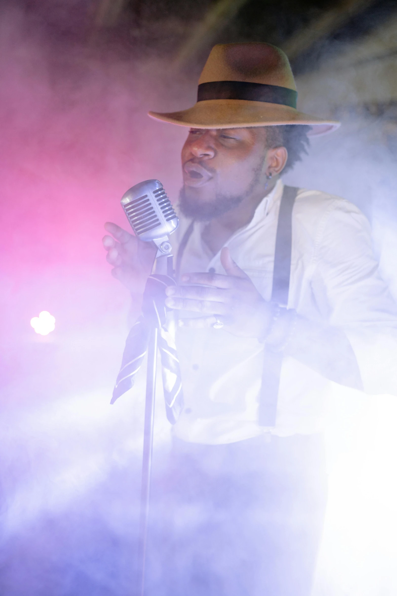 a man in a hat singing into a microphone, inspired by Candido Bido, pexels, conceptual art, : kendrick lamar, square, show light, thumbnail