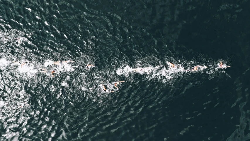 a group of people swimming in a body of water, by Carey Morris, pexels contest winner, minimalism, ironman, taken from orbit, thumbnail, turbulence