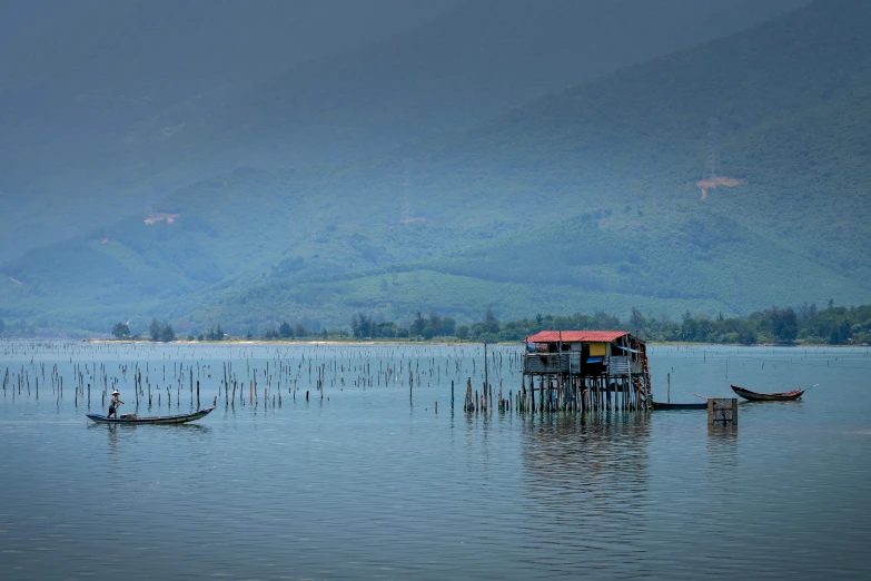 a couple of boats that are in the water, inspired by Steve McCurry, pexels contest winner, sumatraism, bamboo huts, panorama view, phuoc quan, profile image