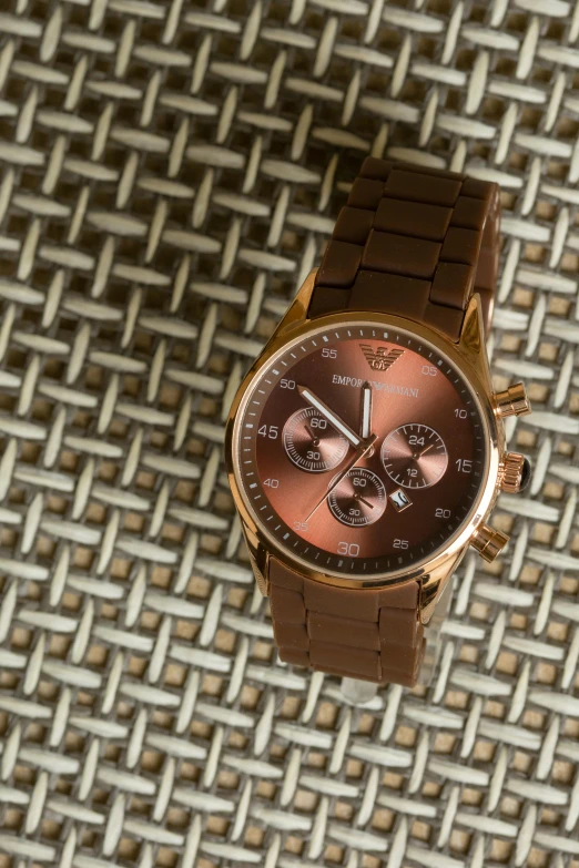 a close up of a watch on a cloth, inspired by Francesco Furini, pexels contest winner, brown resin, thumbnail, brown:-2, rose tones