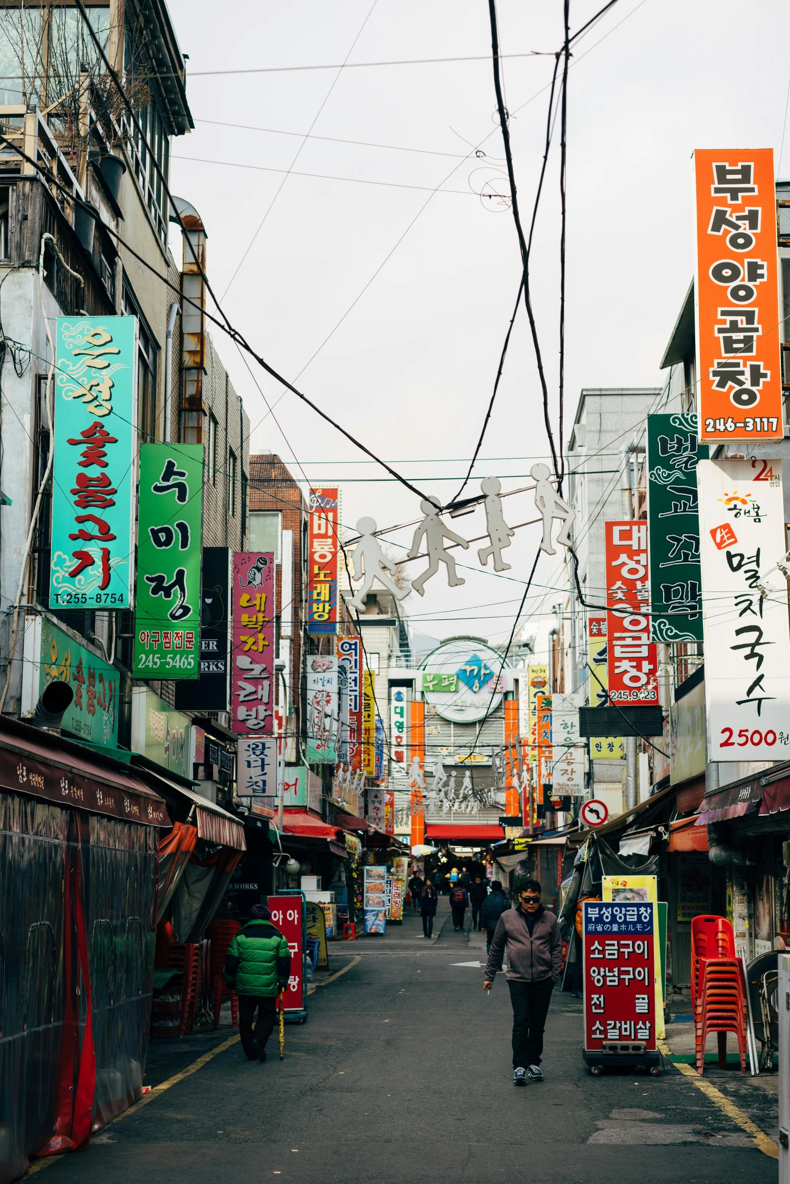 a group of people walking down a street next to tall buildings, inspired by jeonseok lee, trending on unsplash, mingei, old signs, old shops, ethnicity : japanese, square