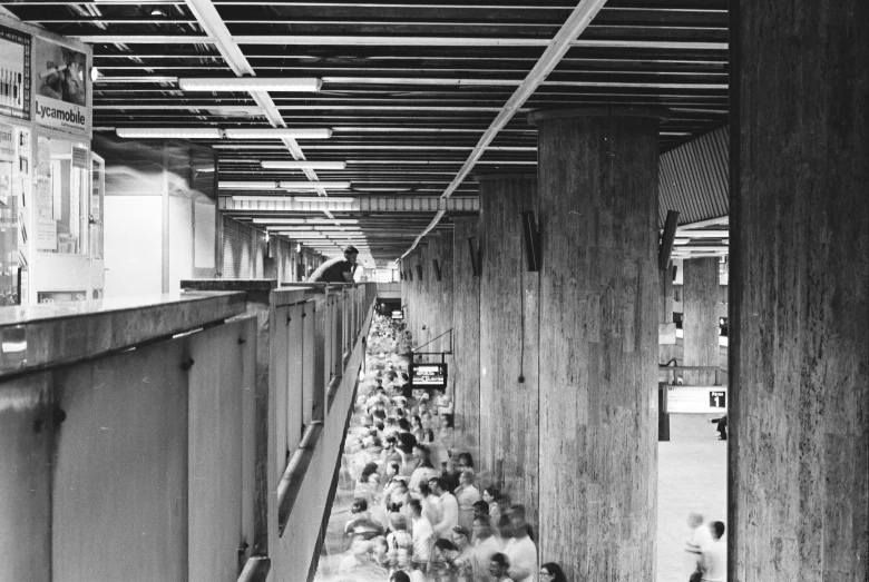 a black and white photo of a long line of people, by Harvey Pratt, brutalism, interior view, marathon, 1960, platform