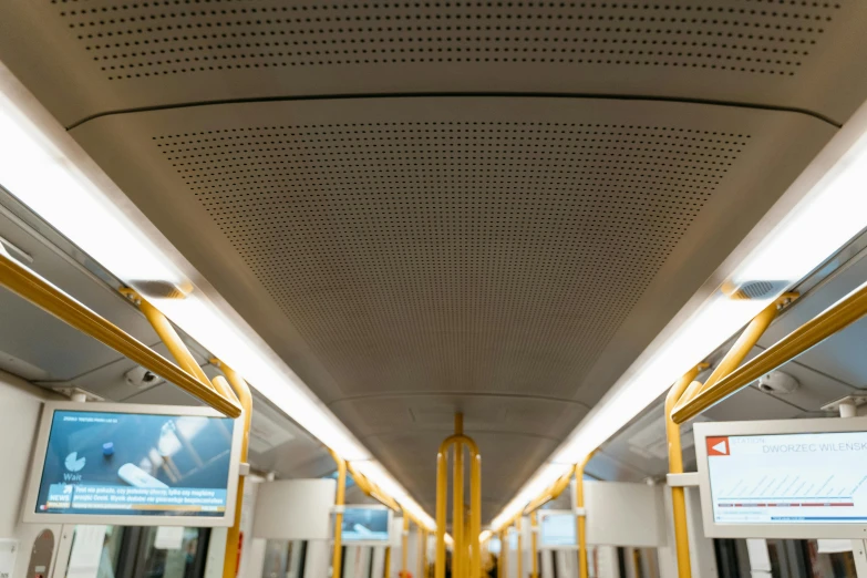 a view of the inside of a subway car, by karlkka, unsplash, yellow street lights, suspended ceiling, australian, white panels