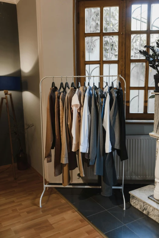 a living room filled with furniture and a fire place, by Jozef Simmler, unsplash, trench coat and suit, laundry hanging, product display, brown