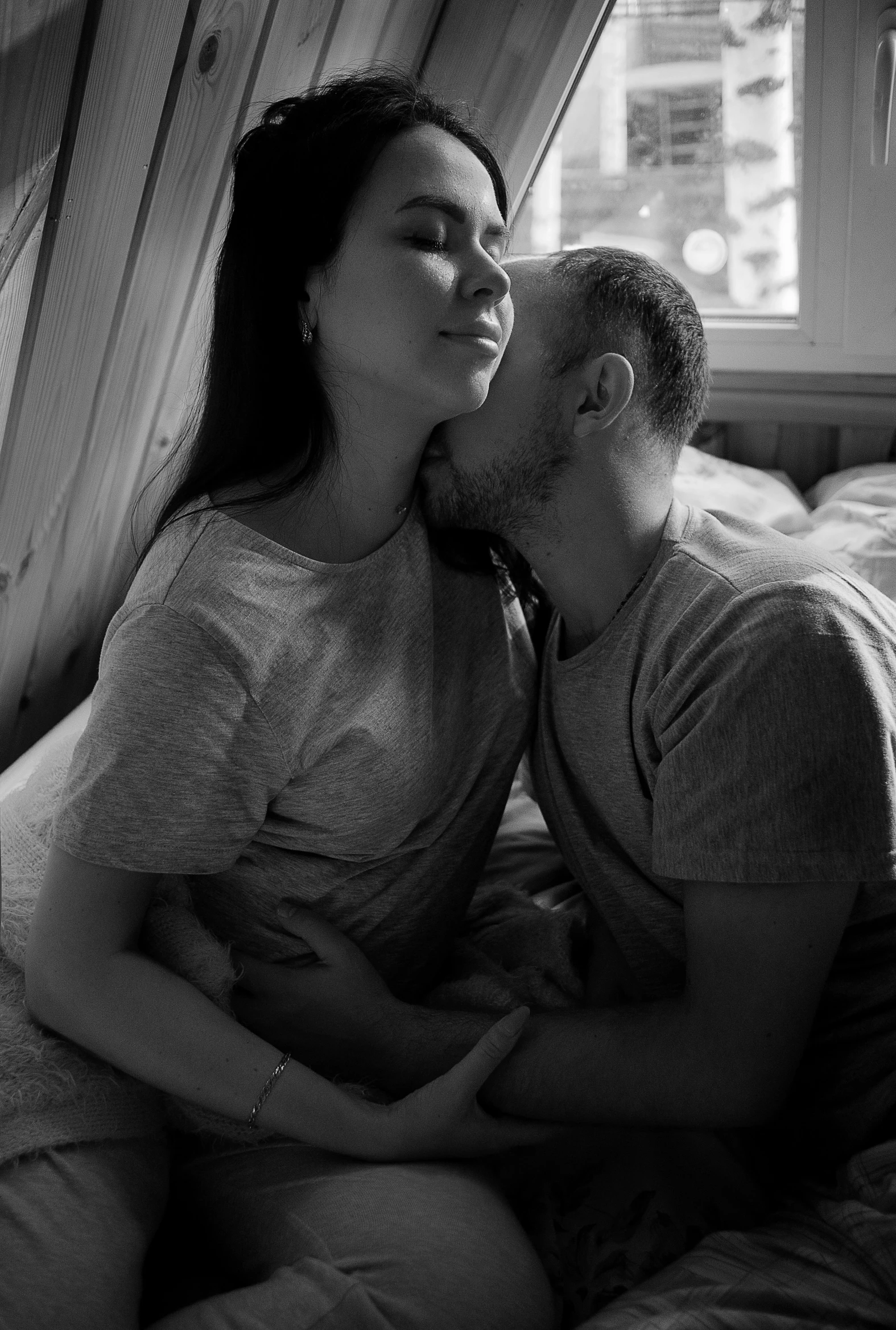 a man and a woman kissing on a bed, a black and white photo, by Adam Marczyński, reddit, pregnant, demna gvasalia, joy ang, 4k)