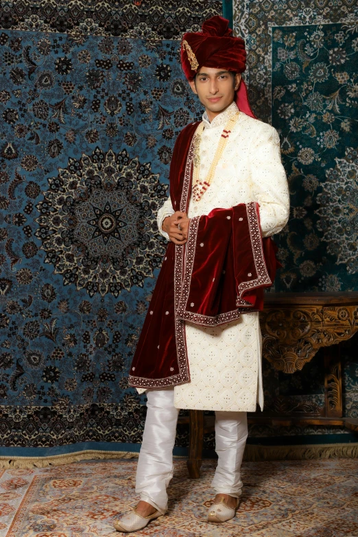 a man in a turban poses for a picture, an album cover, inspired by Osman Hamdi Bey, renaissance, white regal gown, embroidered velvet, thumbnail, wide-shot