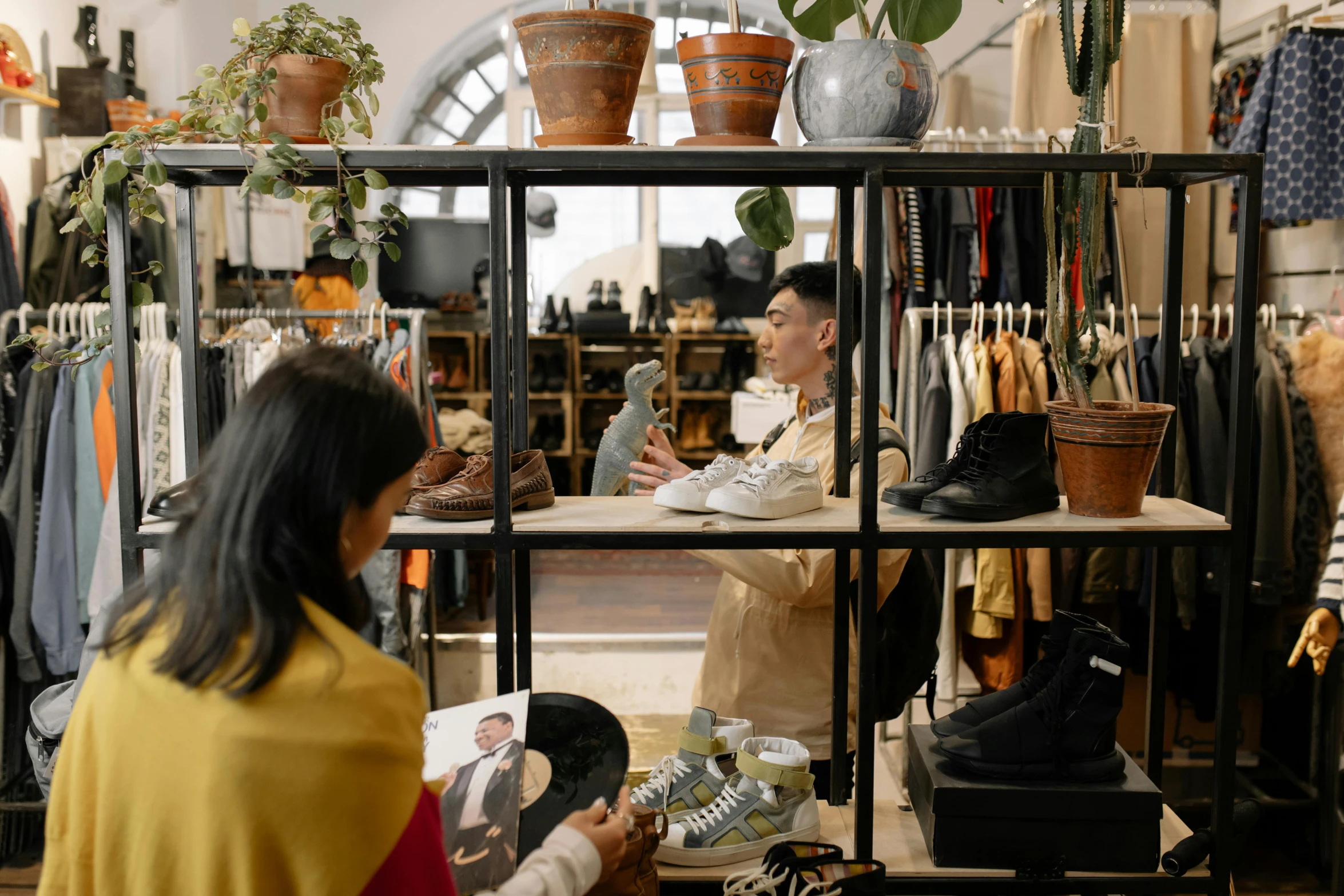 a woman talking to a man in a clothing store, pexels contest winner, focus on sneakers only, green and brown clothes, 🦩🪐🐞👩🏻🦳, asian man