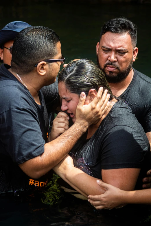 a group of people standing in a body of water, crying, james zapata, closes her eye, holy