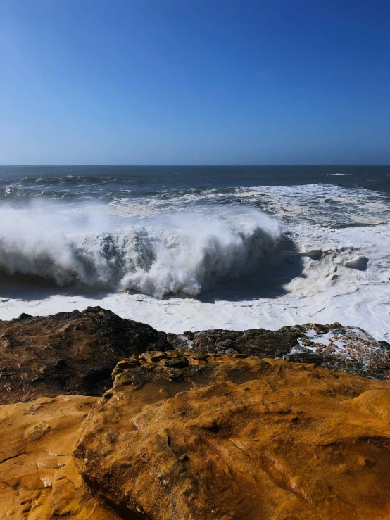 a large body of water sitting on top of a sandy beach, sea storm and big waves cliffs, tar pit, waves of energy, slide show