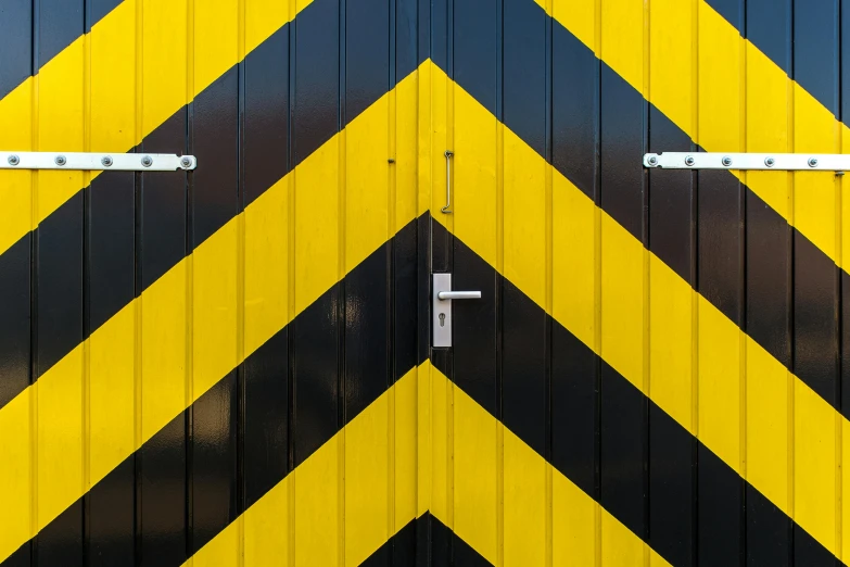 a close up of a yellow and black door, a photo, unsplash, shock art, hazard stripes, square, a wooden, zig zag