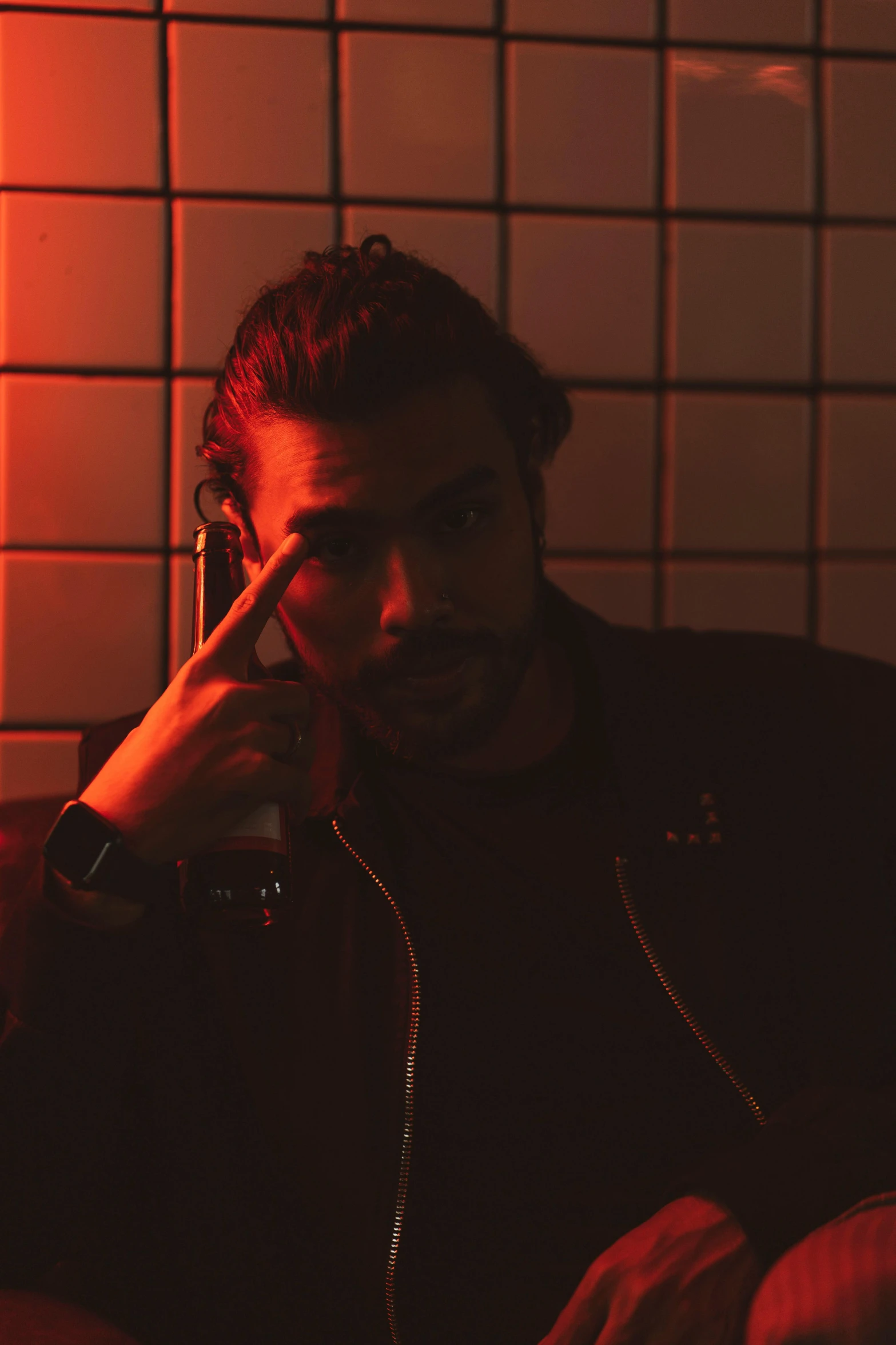 a man sitting on a couch talking on a cell phone, an album cover, inspired by Elsa Bleda, pexels contest winner, red lighting on their faces, reza afshar, in a nightclub, headshot