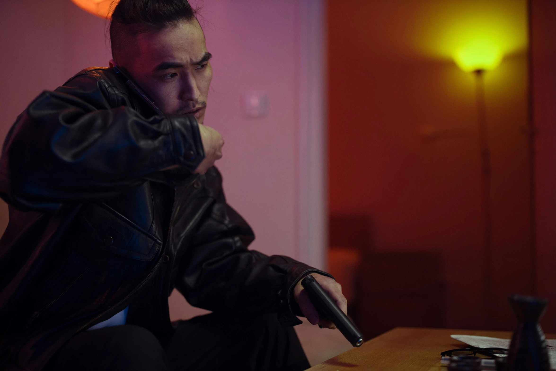 a man in a leather jacket holding a gun, inspired by Liam Wong, cinestill colour, indoor scene, youtube thumbnail, dr zeus