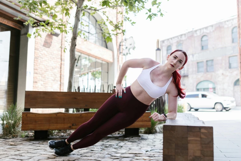 a woman is doing push ups on a bench, a portrait, by Jessie Algie, pexels contest winner, pale skin, train with maroon, new balance pop up store, physical : tinyest midriff ever