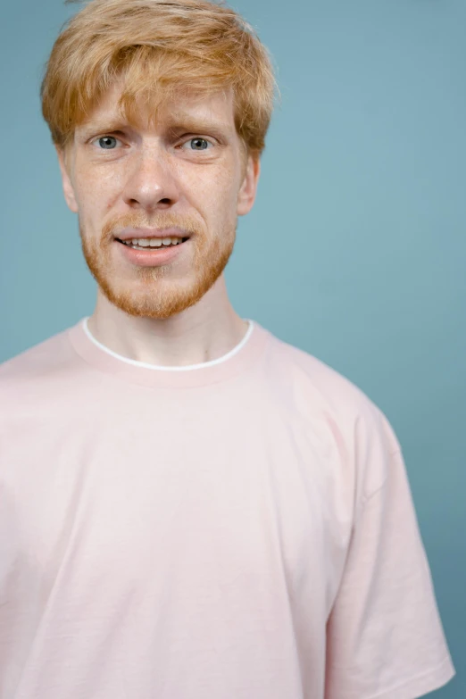 a man with a frisbee in his hand, featured on reddit, hyperrealism, ginger hair with freckles, covered in pink flesh, wearing a light blue shirt, catalog photo