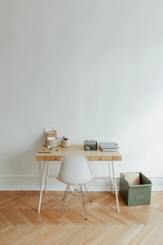 a wooden desk sitting on top of a hard wood floor, a minimalist painting, trending on unsplash, ignant, clean white background, dwell, film photo