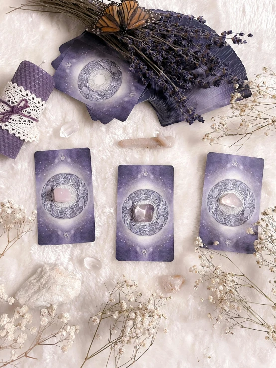 a bunch of cards sitting on top of a table, inspired by Amanda Sage, pexels contest winner, silver and amethyst, moonstone, central shot, inside