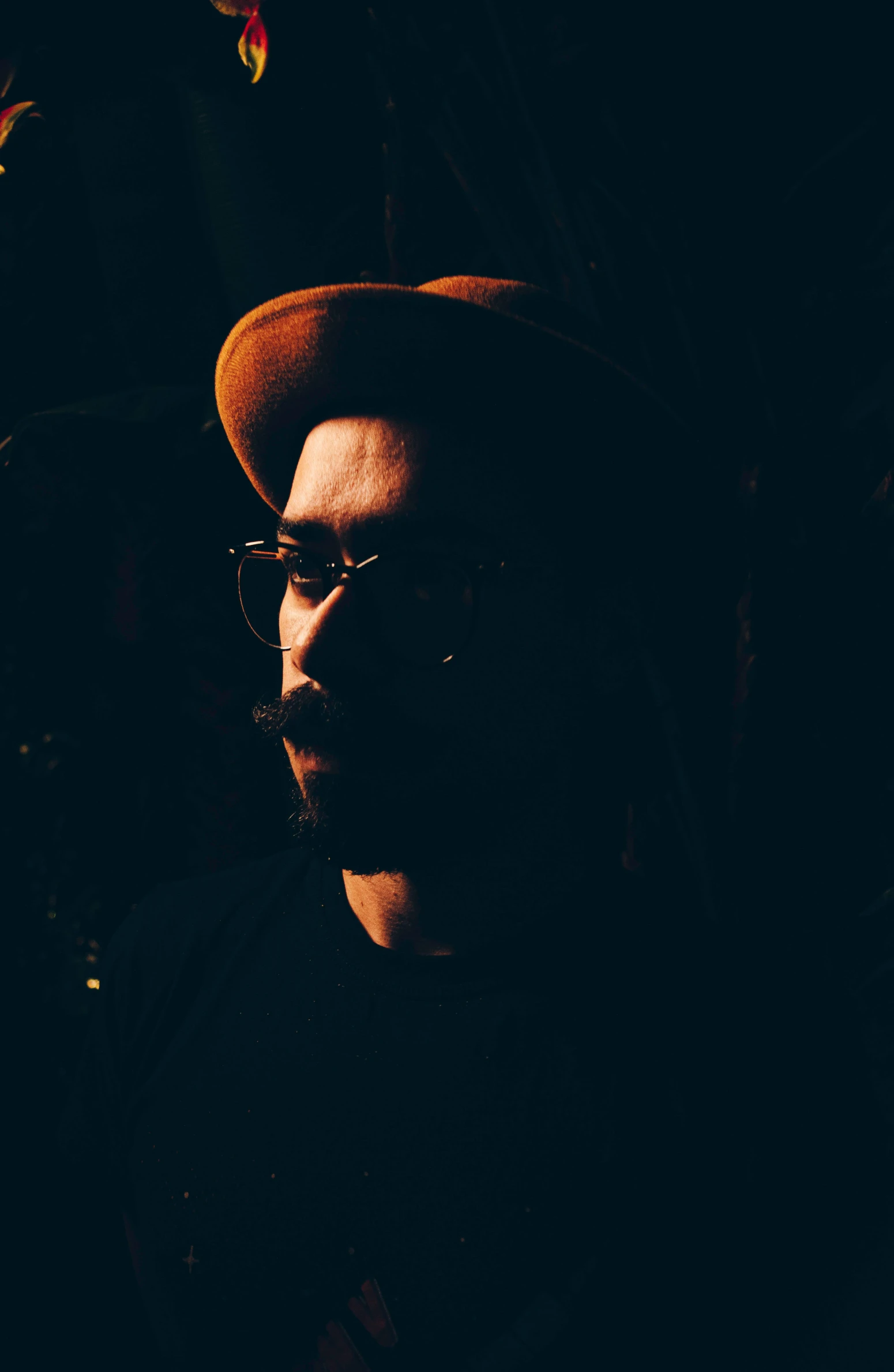 a man wearing a hat and glasses in the dark, unsplash, process art, ((portrait)), redscale photography, profile picture 1024px, low quality grainy