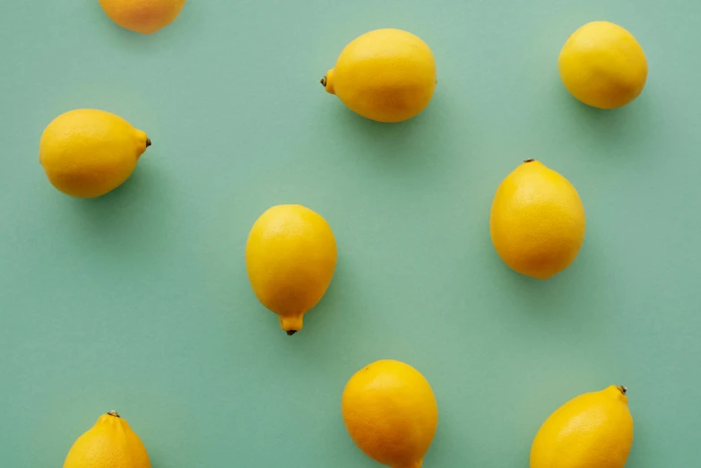 a group of lemons sitting on top of a green surface, high quality product image”, less detailing, bright colour, thumbnail