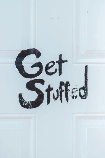 a white door with the words get stuff written on it, featured on reddit, stuffed toy, buffed, promo image, curled up under the covers