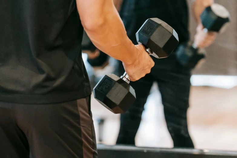 a man lifting two dumbbells in a gym, pexels contest winner, 🦩🪐🐞👩🏻🦳, manly, thumbnail, background image