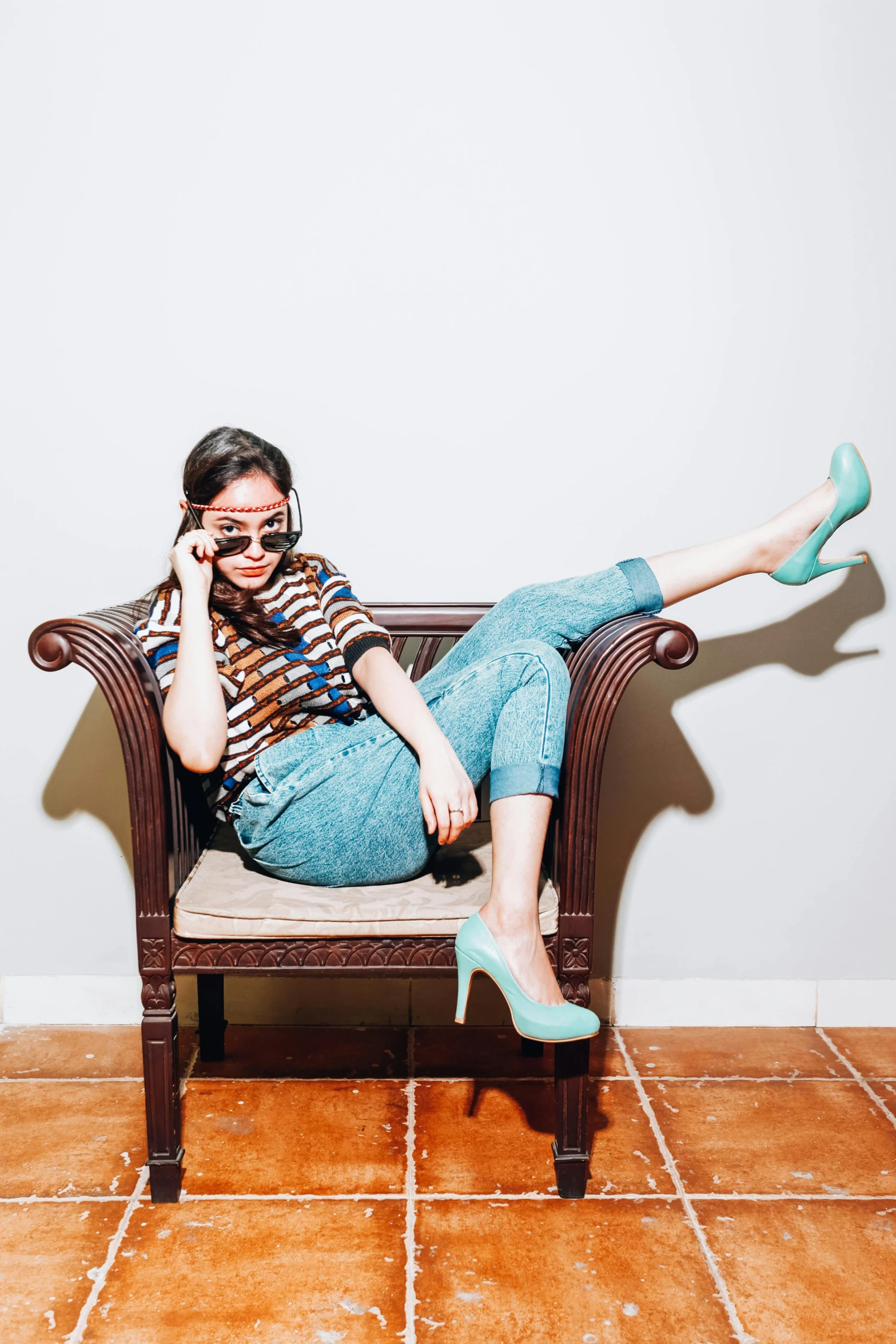 a woman sitting on a chair talking on a cell phone, blue shoes, instagram photo shoot, promo image, patterned