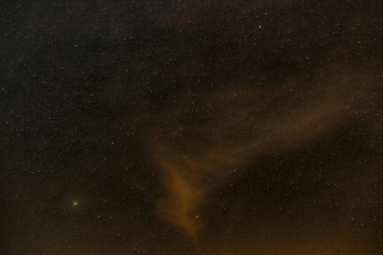 a sky filled with lots of stars next to a body of water, twisting vapour, brown, taken with sony alpha 9, cloud nebula