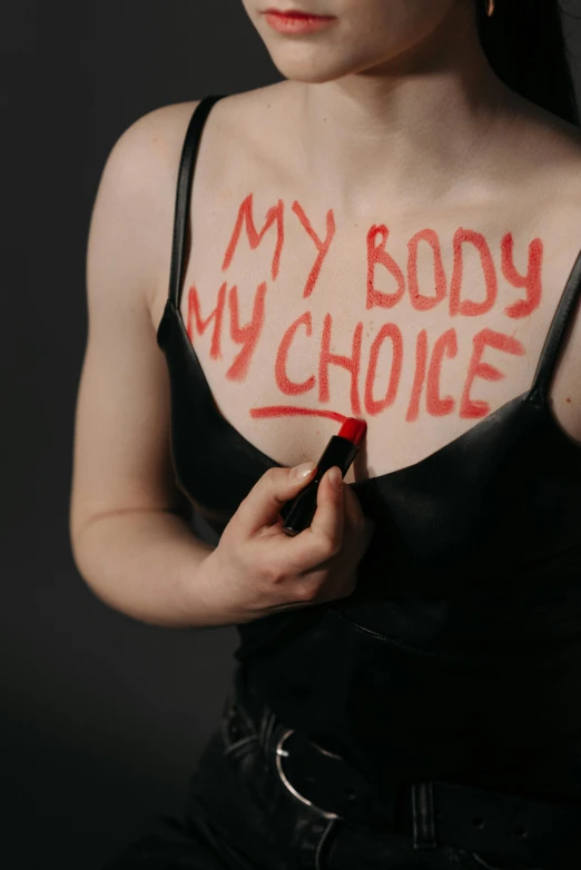 a woman with the words my body is my choice written on her chest, by Matija Jama, cruelty, editors choice, abcdefghijklmnopqrstuvwxyz, blood and body parts