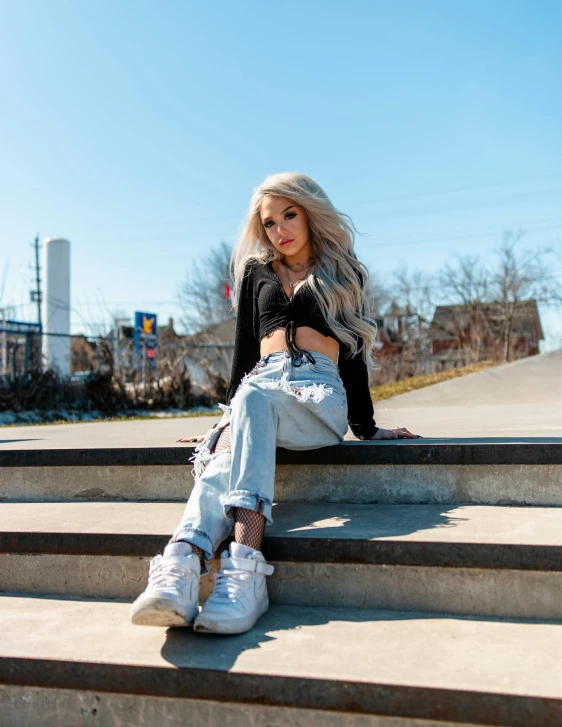 a woman sitting on a set of stairs, by Robbie Trevino, trending on pexels, ava max, wearing white sneakers, sunny day time, jessica nigri