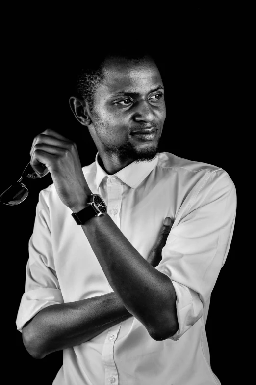 a black and white photo of a man holding a pair of scissors, by Chinwe Chukwuogo-Roy, les nabis, wearing a white button up shirt, professional photo-n 3, ((portrait)), profile photography