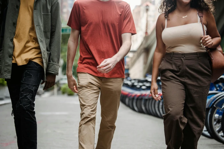 a group of people walking down a street, trending on pexels, red shirt brown pants, background image, commercial banner, environmental shot