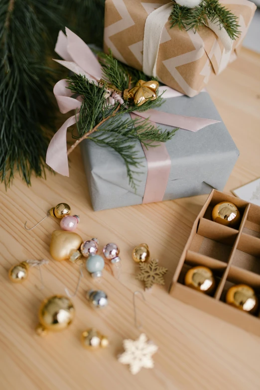 a bunch of presents sitting on top of a wooden table, by Julia Pishtar, trending on pexels, golden ornaments, grey, bells, thumbnail