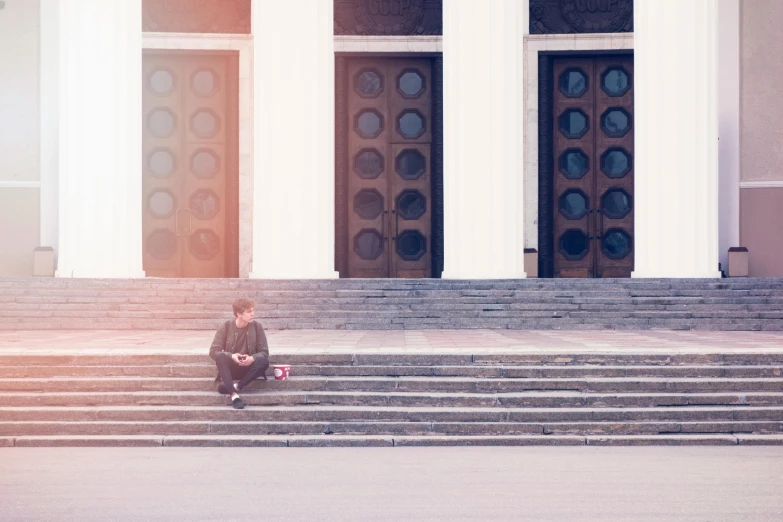 a young boy sitting on the steps of a building, a picture, by Emma Andijewska, pexels contest winner, on a great neoclassical square, artistic. alena aenami, without text, in front of the temple